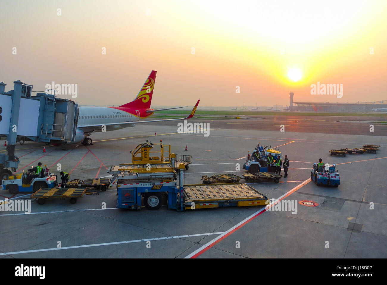 Beijing, China-May 19, 2016: The aircraft of Hainan Airlines is parked at the aerobridge of Beijing capital international airport with ground handling Stock Photo