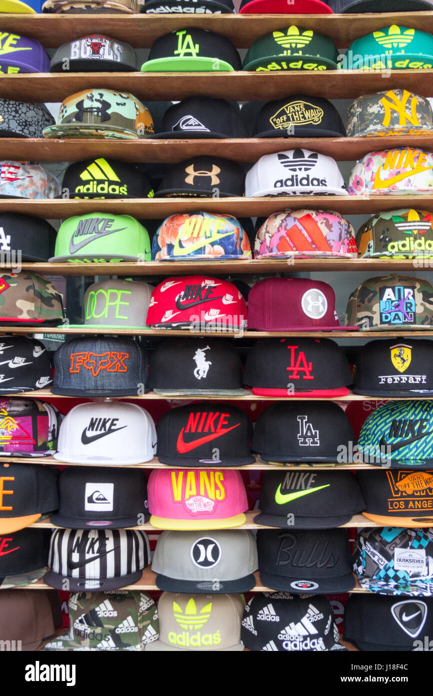 Hats on shelves on a vendor's street stall on Bangla Road, Patong beach,  Phuket, Thailand Stock Photo - Alamy