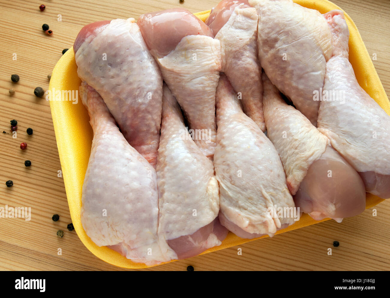 Download Chicken Legs In The Yellow Tray On A Wooden Surface Stock Photo Alamy Yellowimages Mockups