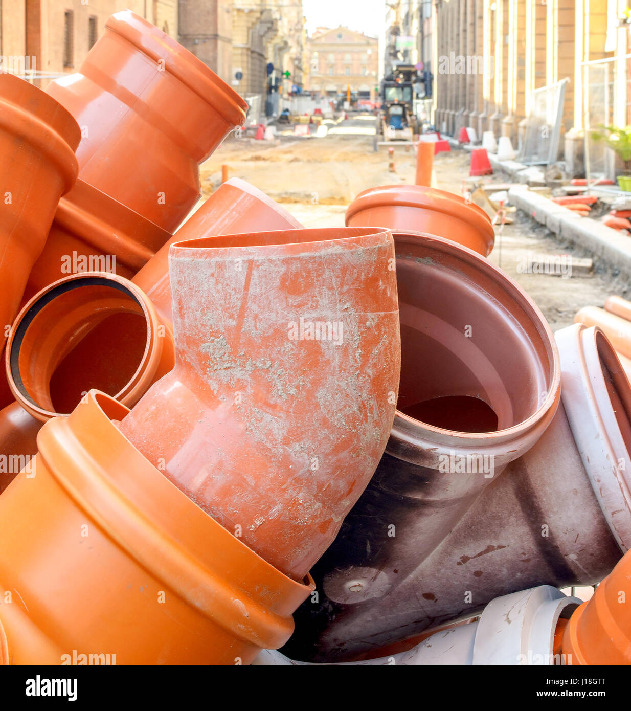 PVC sewer pipe joint plastic pipework orange road work surfacing Stock