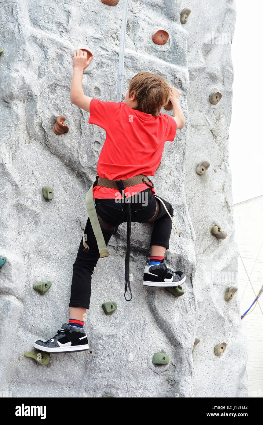 A teenage boy on a Climbing Wall Stock Photo Alamy