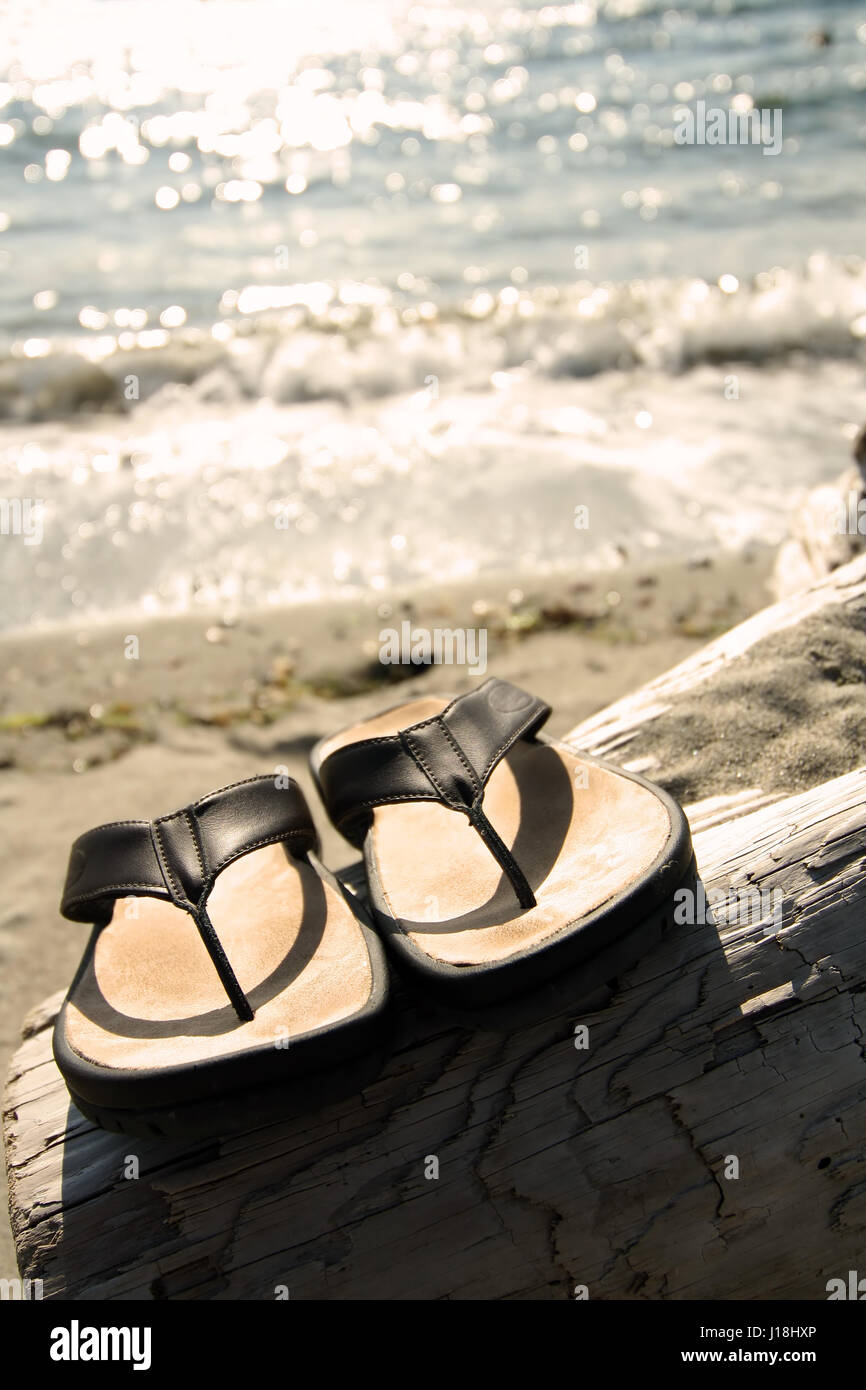 Sandals on the beach Stock Photo - Alamy
