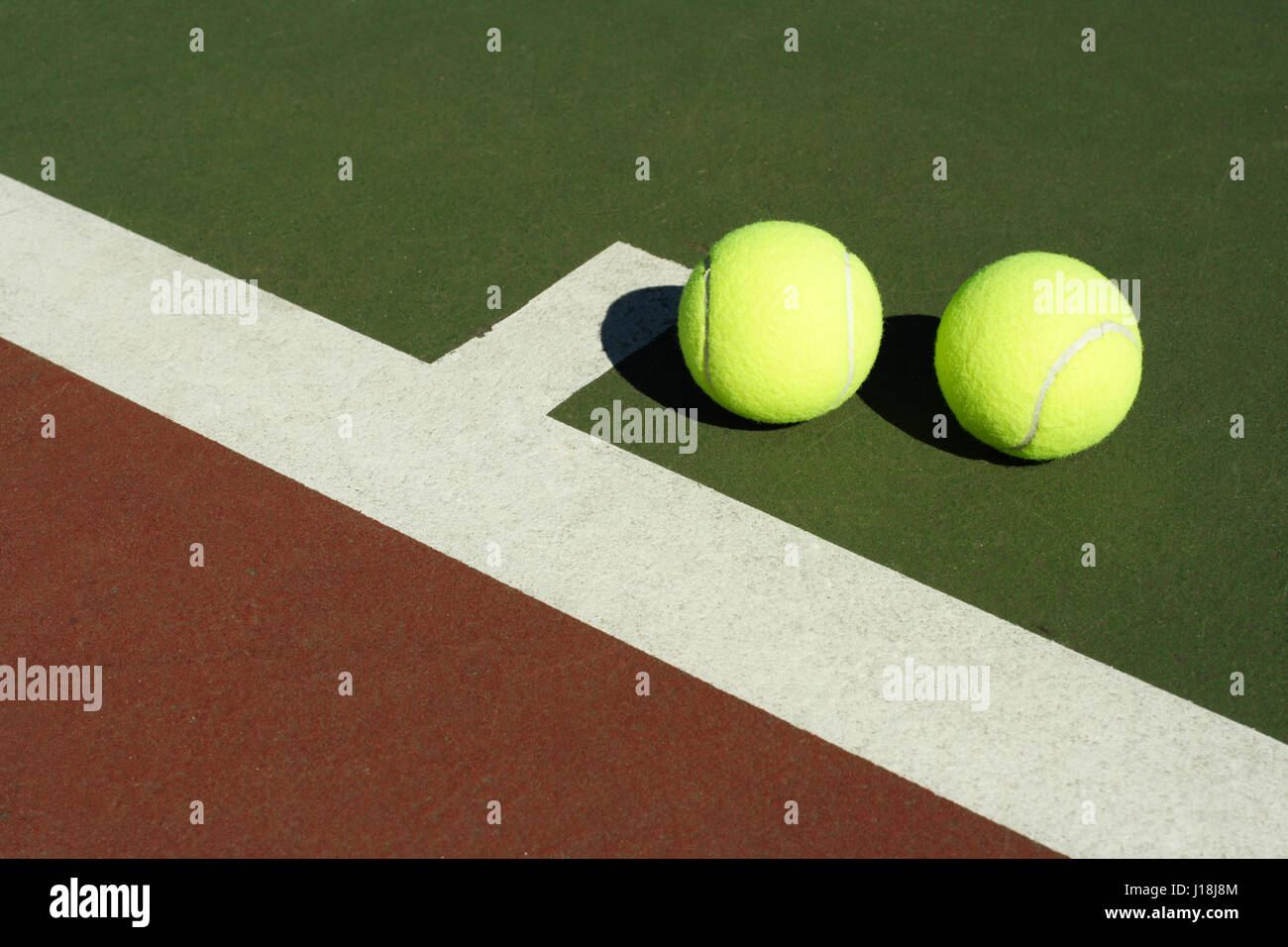Two tennis balls in a tennis court Stock Photo Alamy