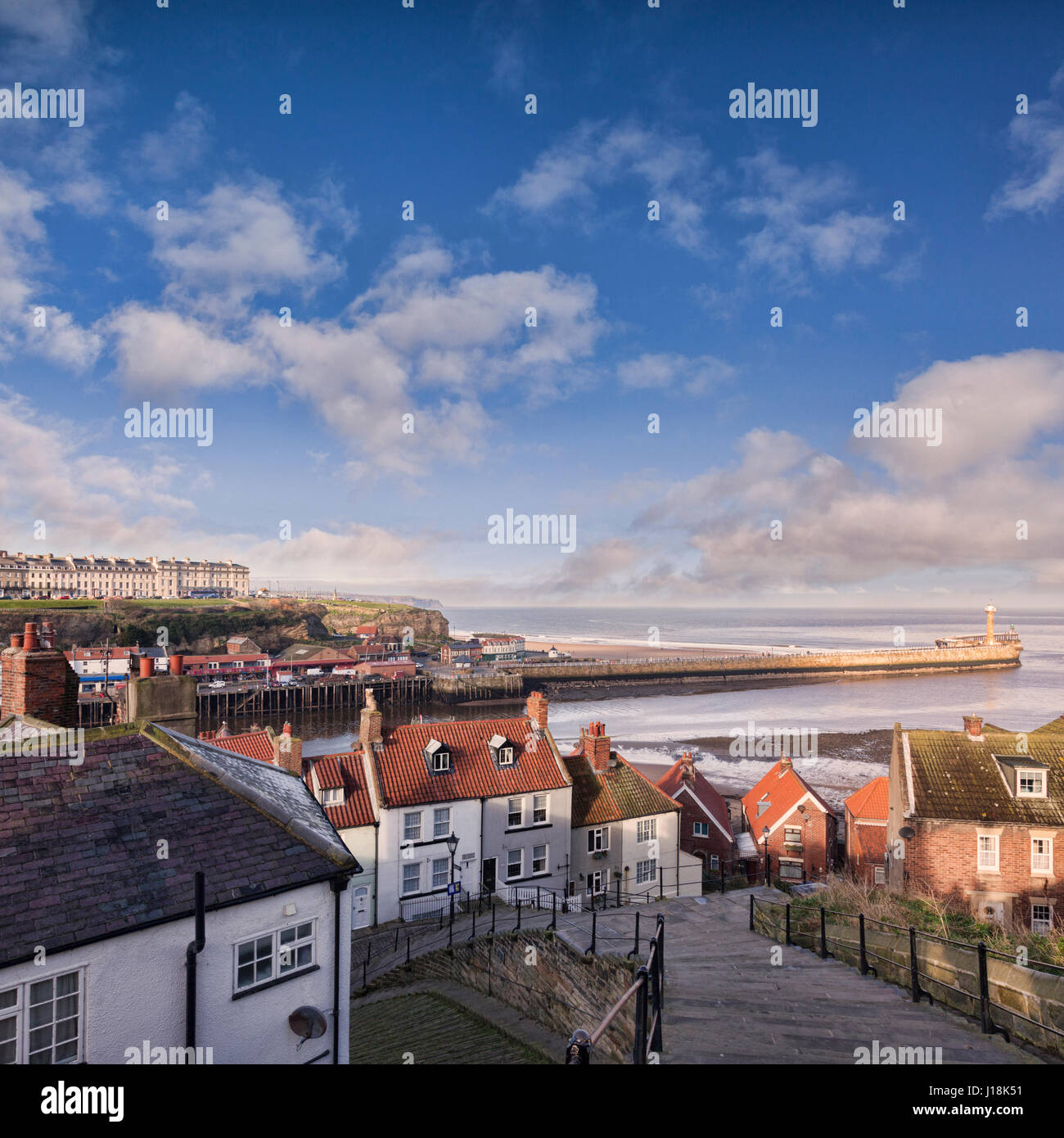 The fishing port of Whitby, North Yorkshire, England, UK, on a sunny winter morning, and the famous 199 steps leading from Church Street to the abbey, Stock Photo