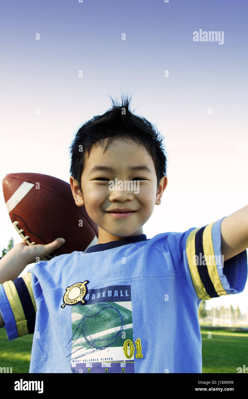 A boy throwing a football Stock Photo Alamy