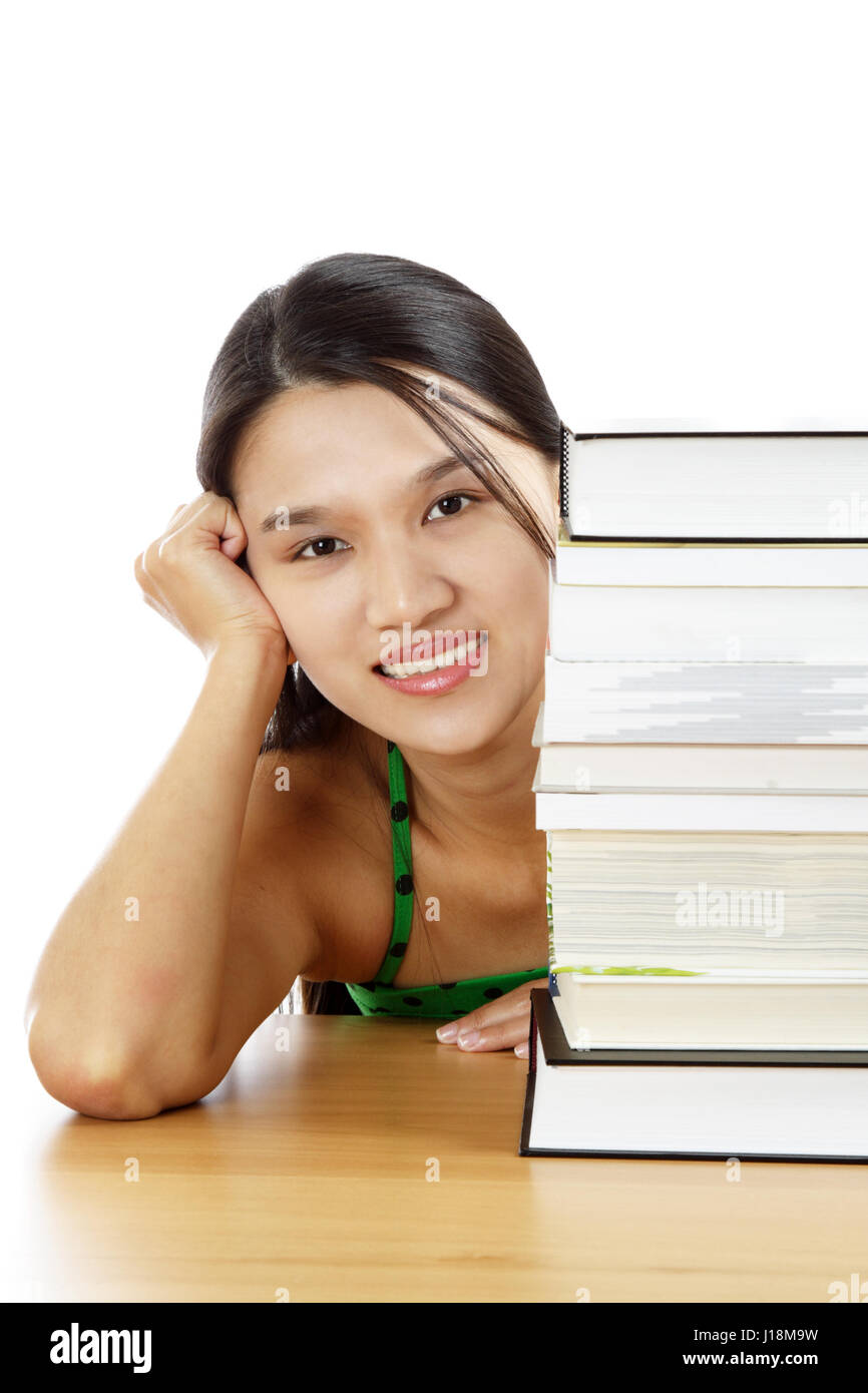 A young girl with a stack of books Stock Photo - Alamy