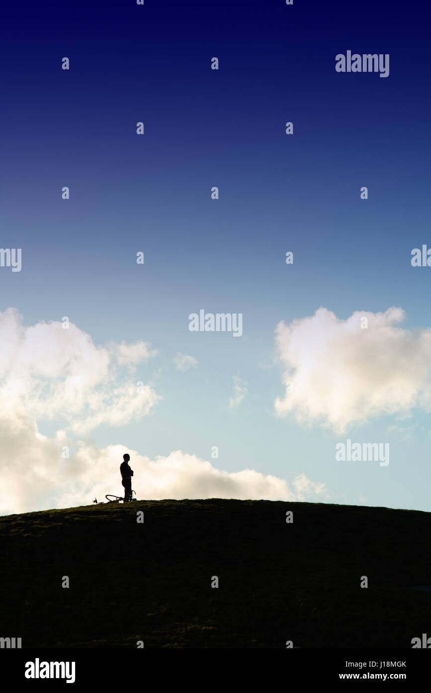 A silhouette man standing on top of the hill Stock Photo - Alamy
