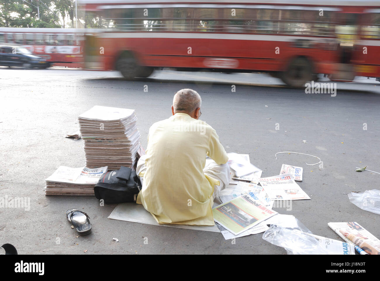 Newspaper vendor sitting on road, mumbai, maharashtra, india, asia Stock Photo