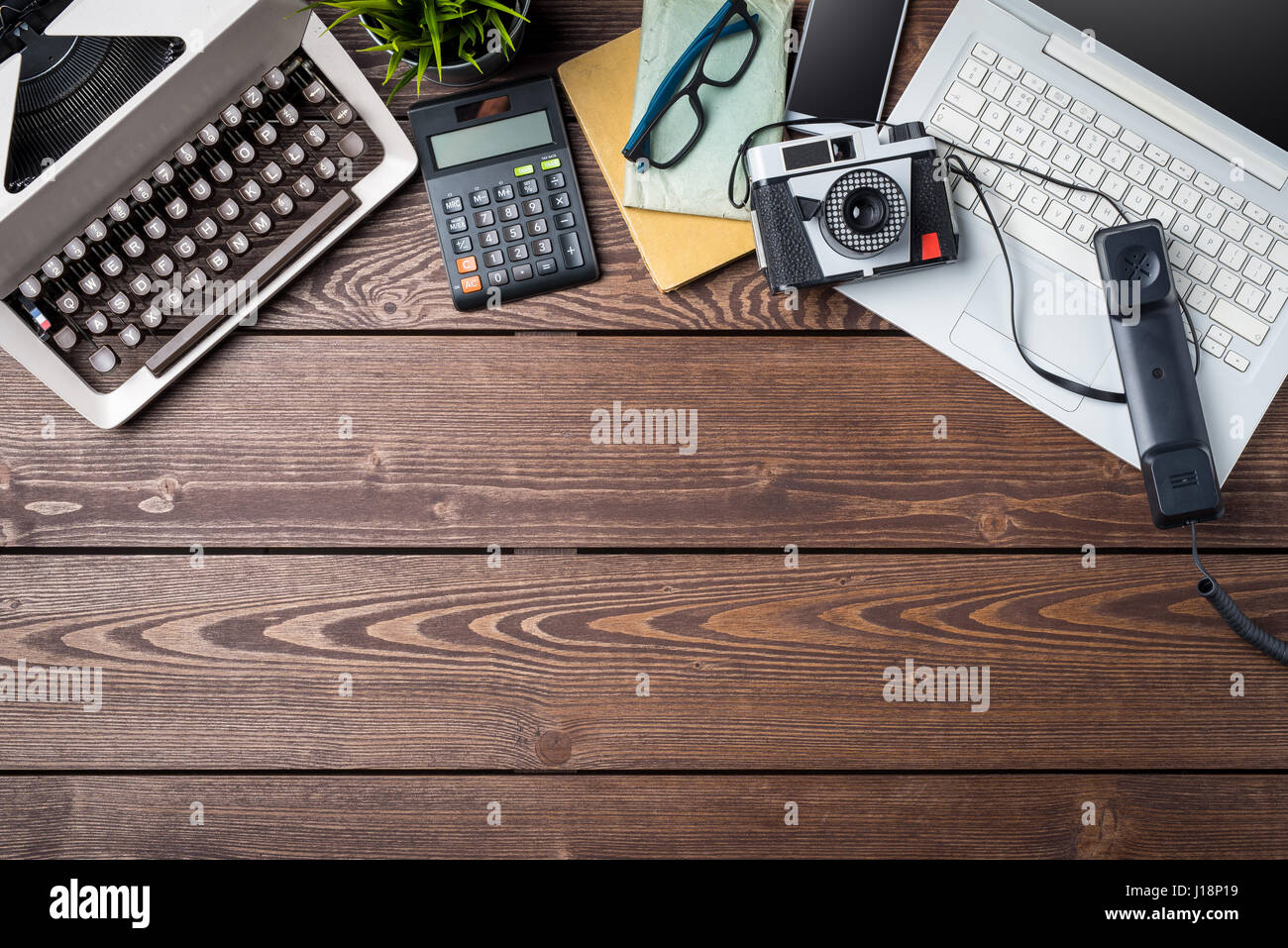 Old and modern devices on wooden table. Technology progress concept Stock Photo