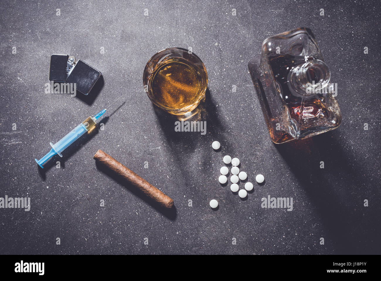 Hard drugs and alcohol on dark stone table. Top view Stock Photo