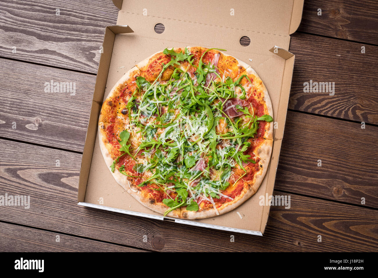 Italian Pizza In Cardboard Box On Wooden Table Top View Stock Photo Alamy