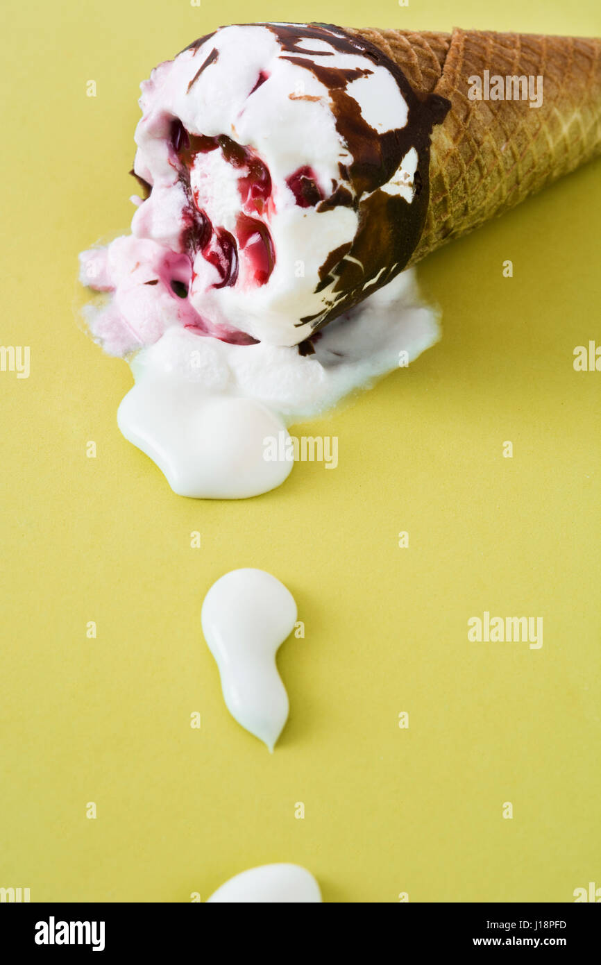 Strawberry ice cream cone on yellow background Stock Photo