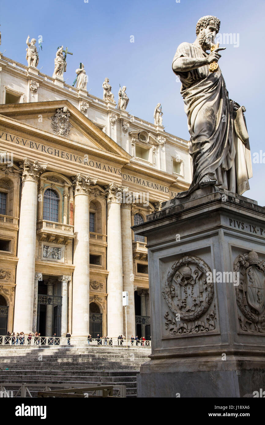 A statue of St. Peter holding the key to the kingdom stands in front of St. Peter's Basilica