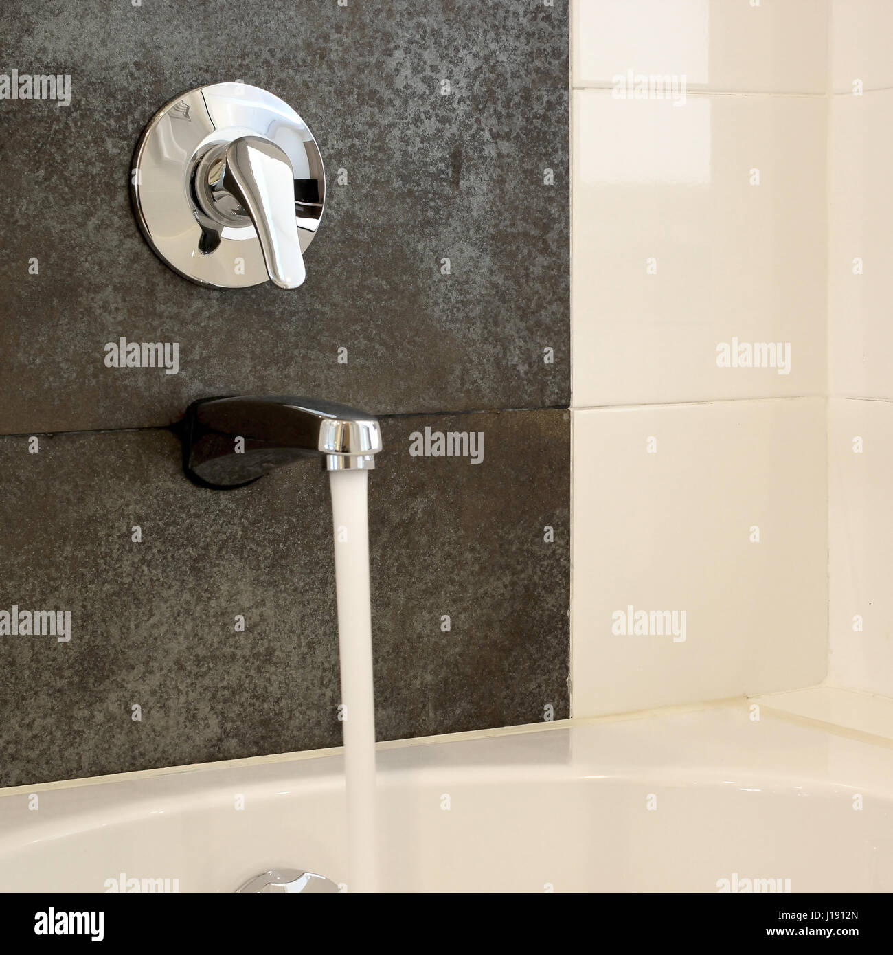 modern bathtub with running water from faucet Stock Photo Alamy