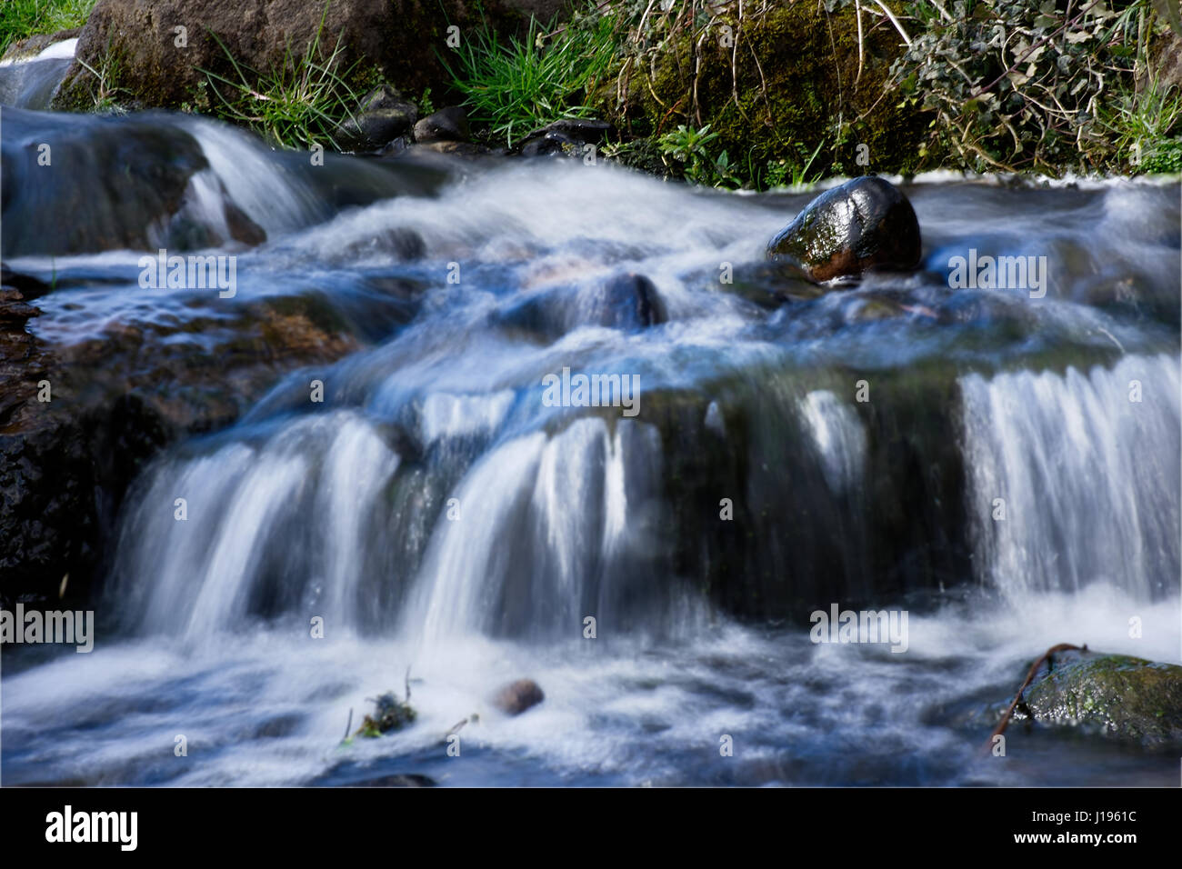 Small waterfall on a mountain stream. Motion and texture of flowing ...