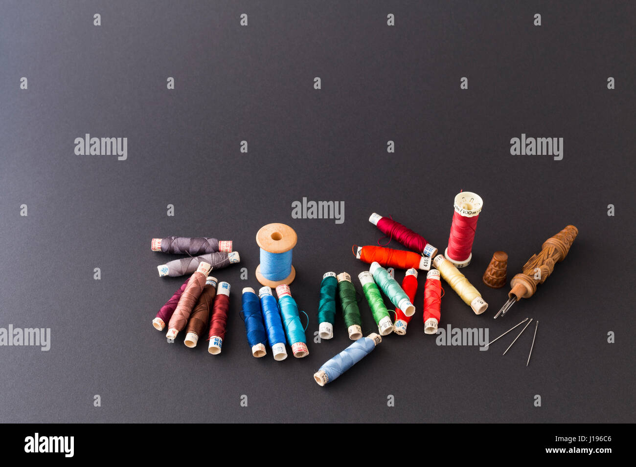 Different rolls with red, blue and green polyester and silk thread