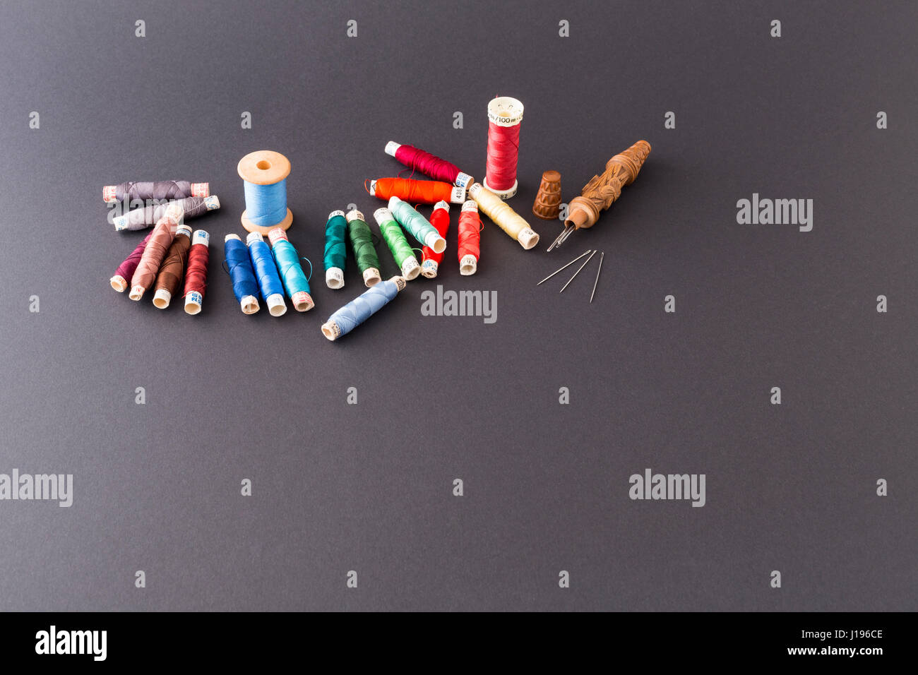 Different rolls with red, blue and green polyester and silk thread ...