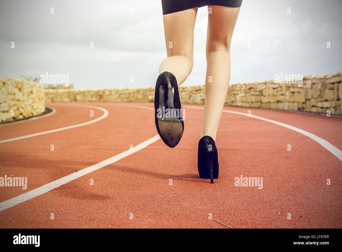Businesswoman running in heels Stock Photo Alamy