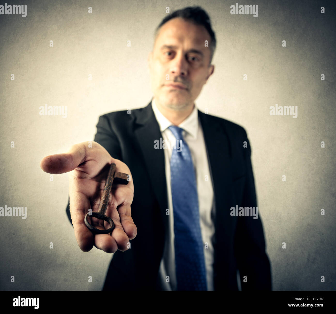 Businessman giving you keys Stock Photo