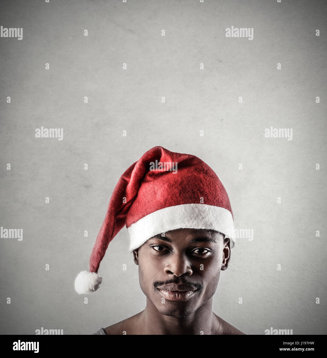 Black man in Santa hat Stock Photo