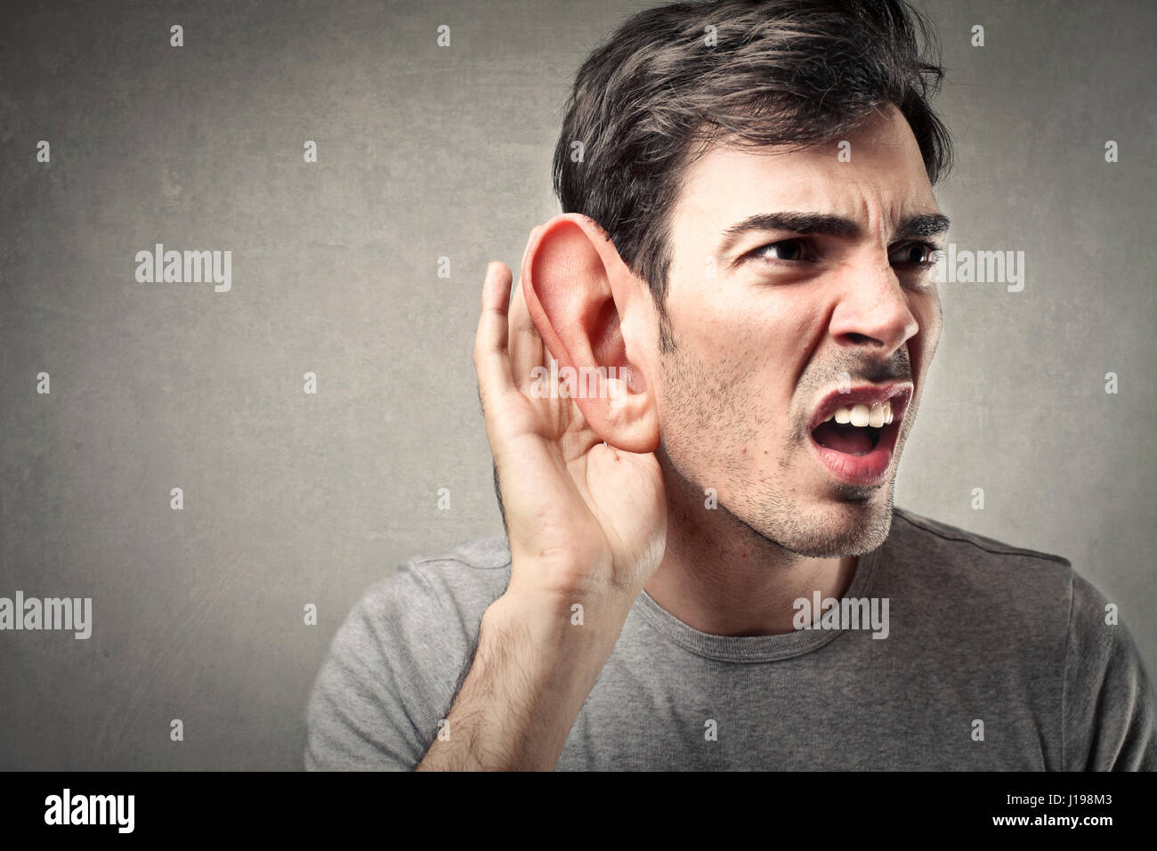 Man listening with his big ear Stock Photo Alamy