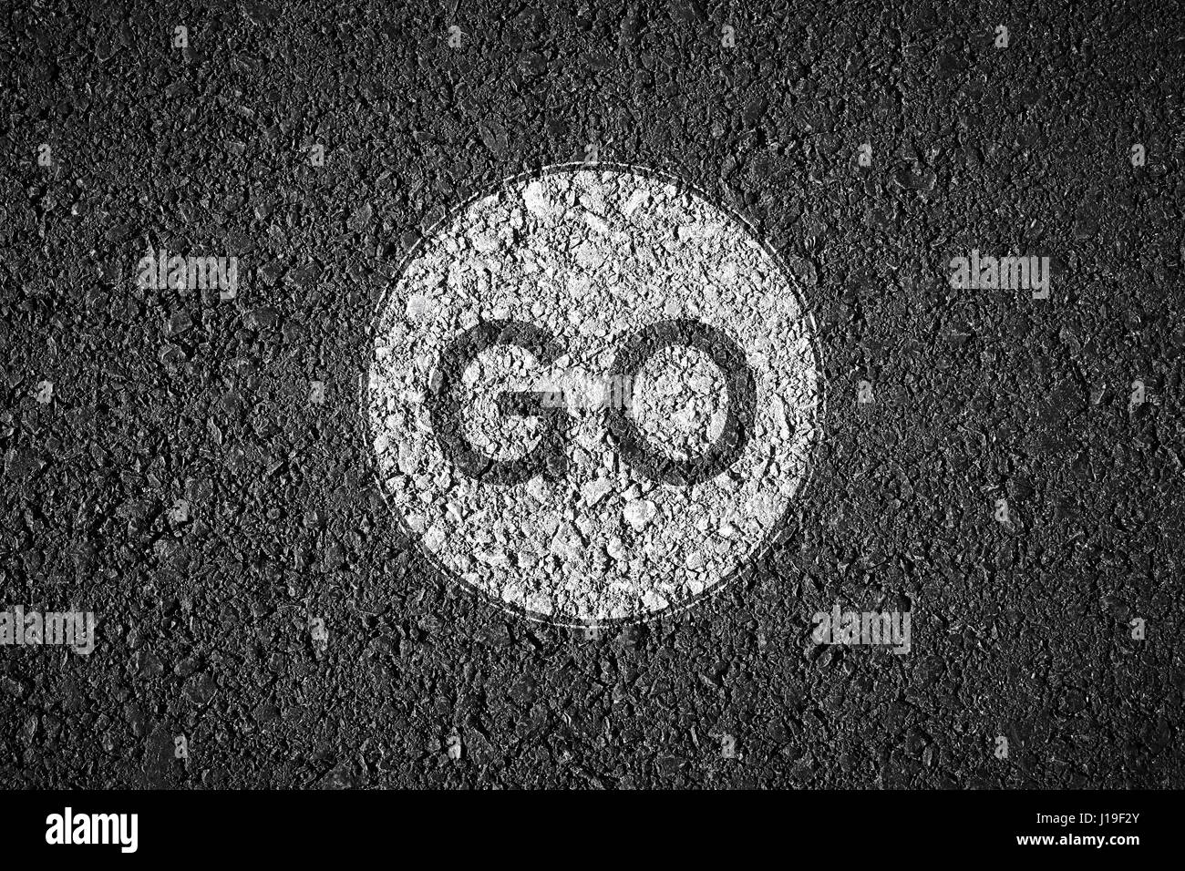 writing go on asphalt texture Stock Photo