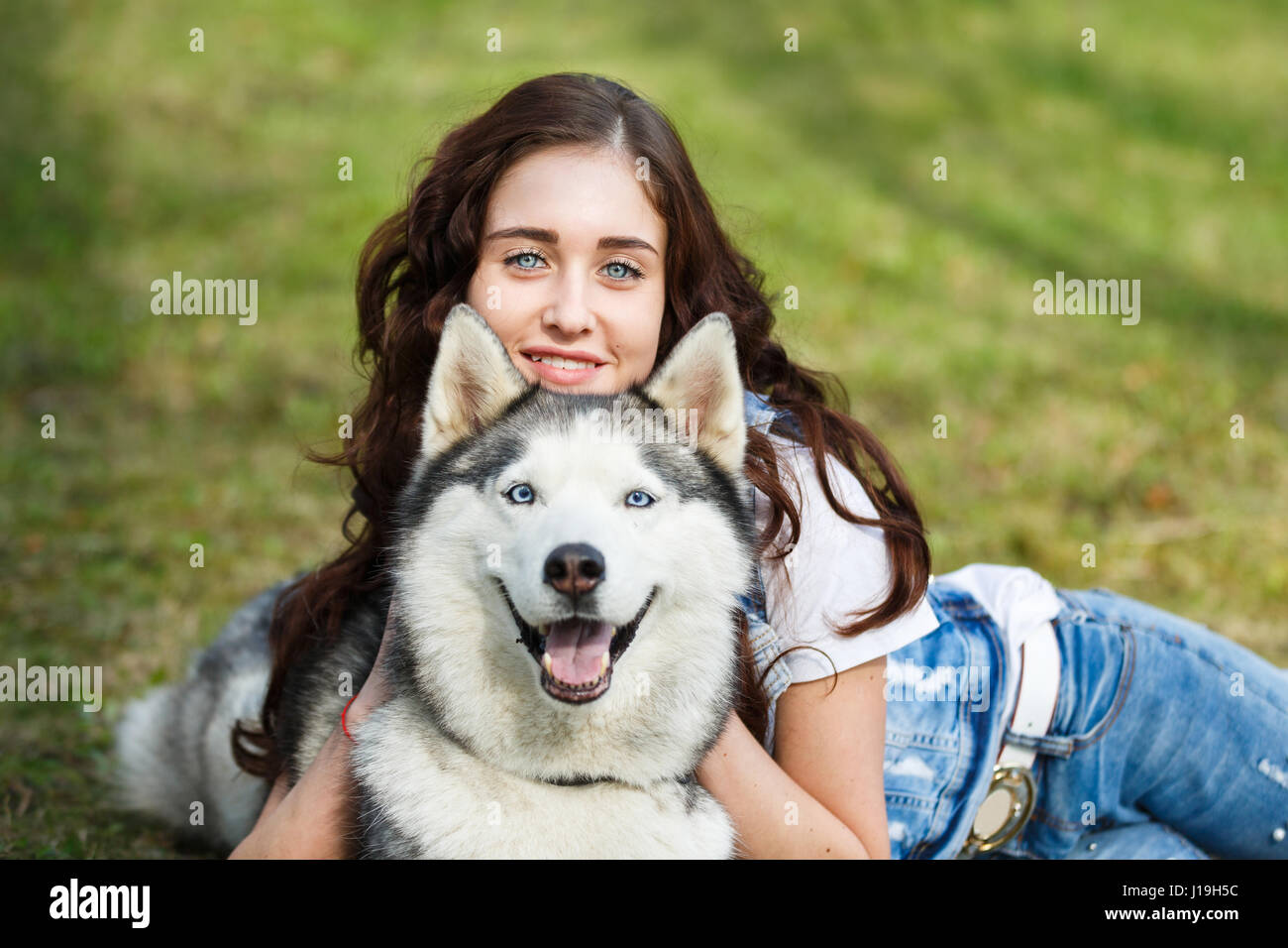 Teenage girl is hugging the husky dog outdoors Stock Photo - Alamy
