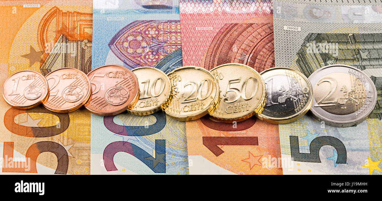 row of all euro cent coins on bank notes wide panorama finance background Stock Photo