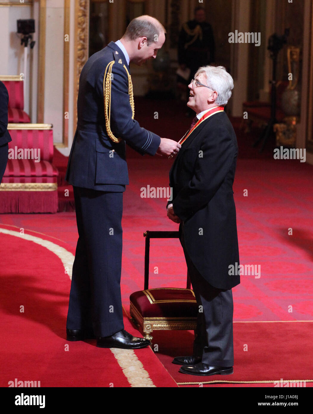 Sir David Sloman from London is made a Knight Bachelor of the British Empire by the Duke of Cambridge at Buckingham Palace. Stock Photo