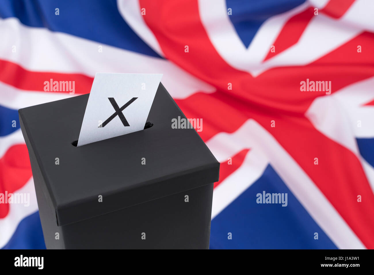 Replica black ballot box set against UK flag / Union Jack as metaphor for concept of 2024 General Election - the Brexit Election. Also mock election. Stock Photo