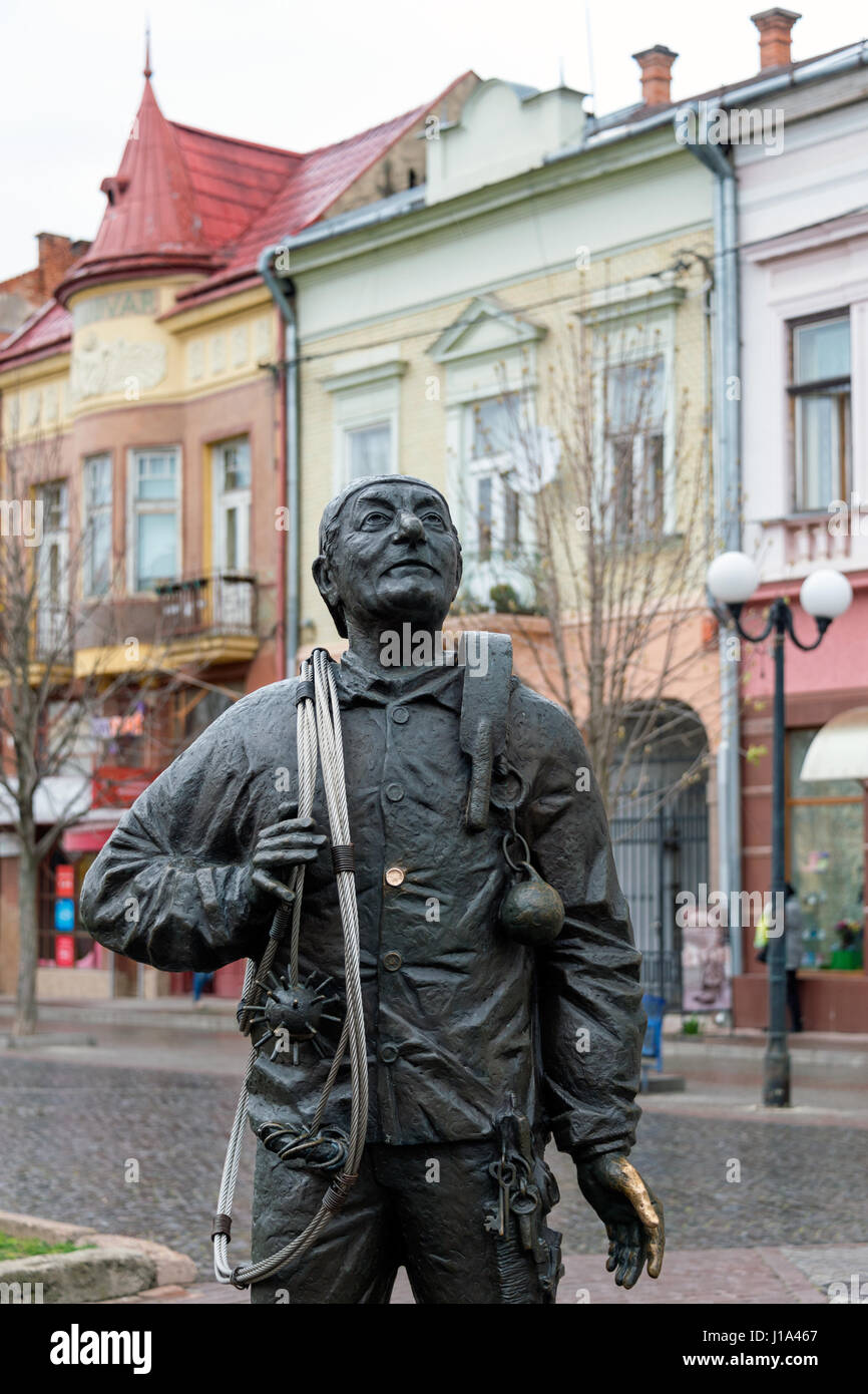 Mukachevo, Ukraine - April 6, 2015: Monument of Happy Chimney Sweeper and his cat. The monument with real chimney sweeper Bertalon Tovt by Ukrainian sculptor Ivan Brovdi. Stock Photo