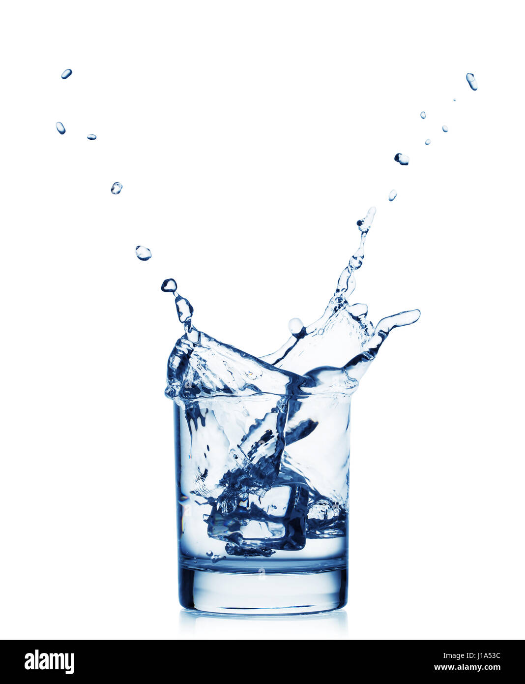 Splash of water in a wide glass with ice isolated on white background ...