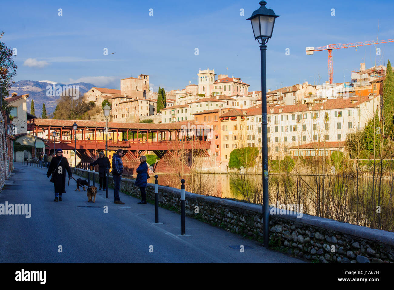 BASSANO DEL GRAPPA, ITALY - JAN 31, 2015: Scene of The Ponte Vecchio (or Ponte degli Alpini) bridge, with local and tourists, and the Brenta river, in Stock Photo