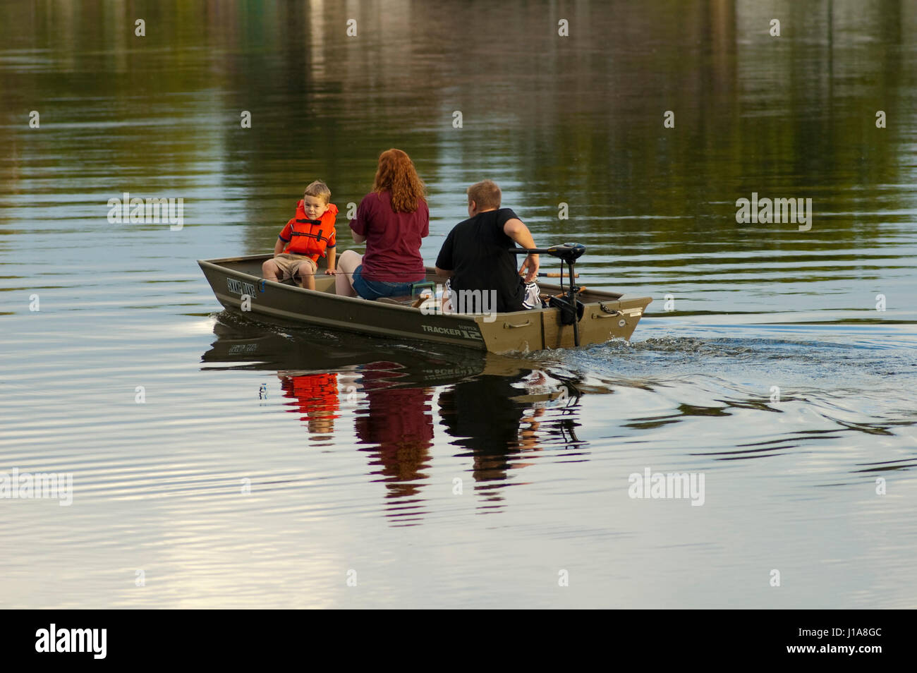 people fishing in john boat two kids one adult Stock Photo - Alamy