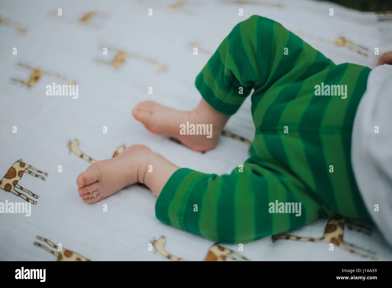 Baby's feet are seen laying on a blanket Stock Photo Alamy