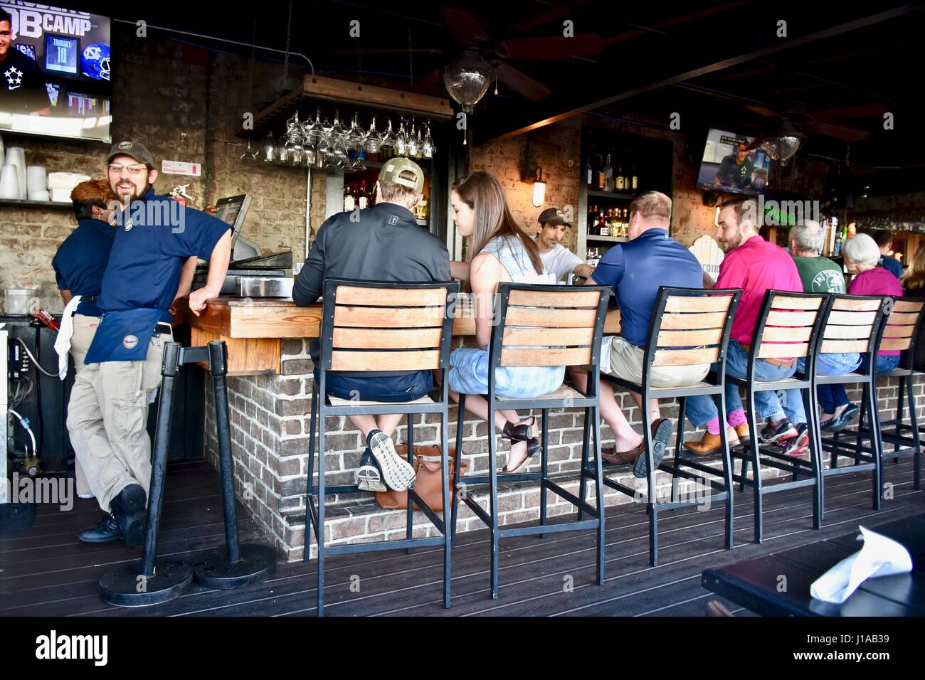 Customers sitting at restaurant bar Stock Photo