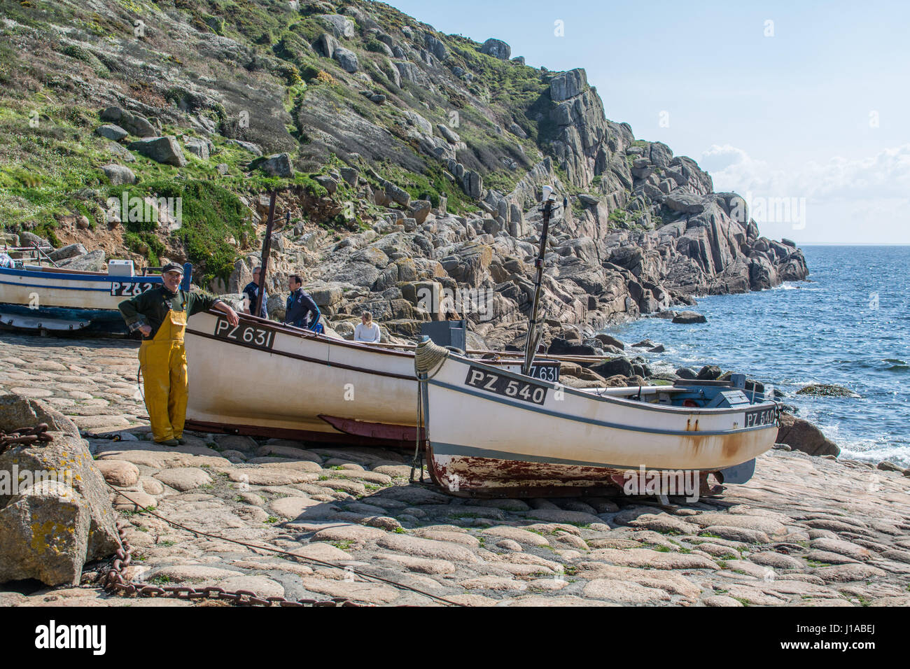 Penberth Cove, Cornwall, UK. 19th April 2017. UK Weather. A fisherman landing his catch of Pollocks on a sunny morning. The boats on Penberth Cove have to be winched up the rocky slipway. The cove is one of the film locations for the next series of the BBC Poldark Series, staring Aidan Turner. Credit: cwallpix/Alamy Live News Stock Photo