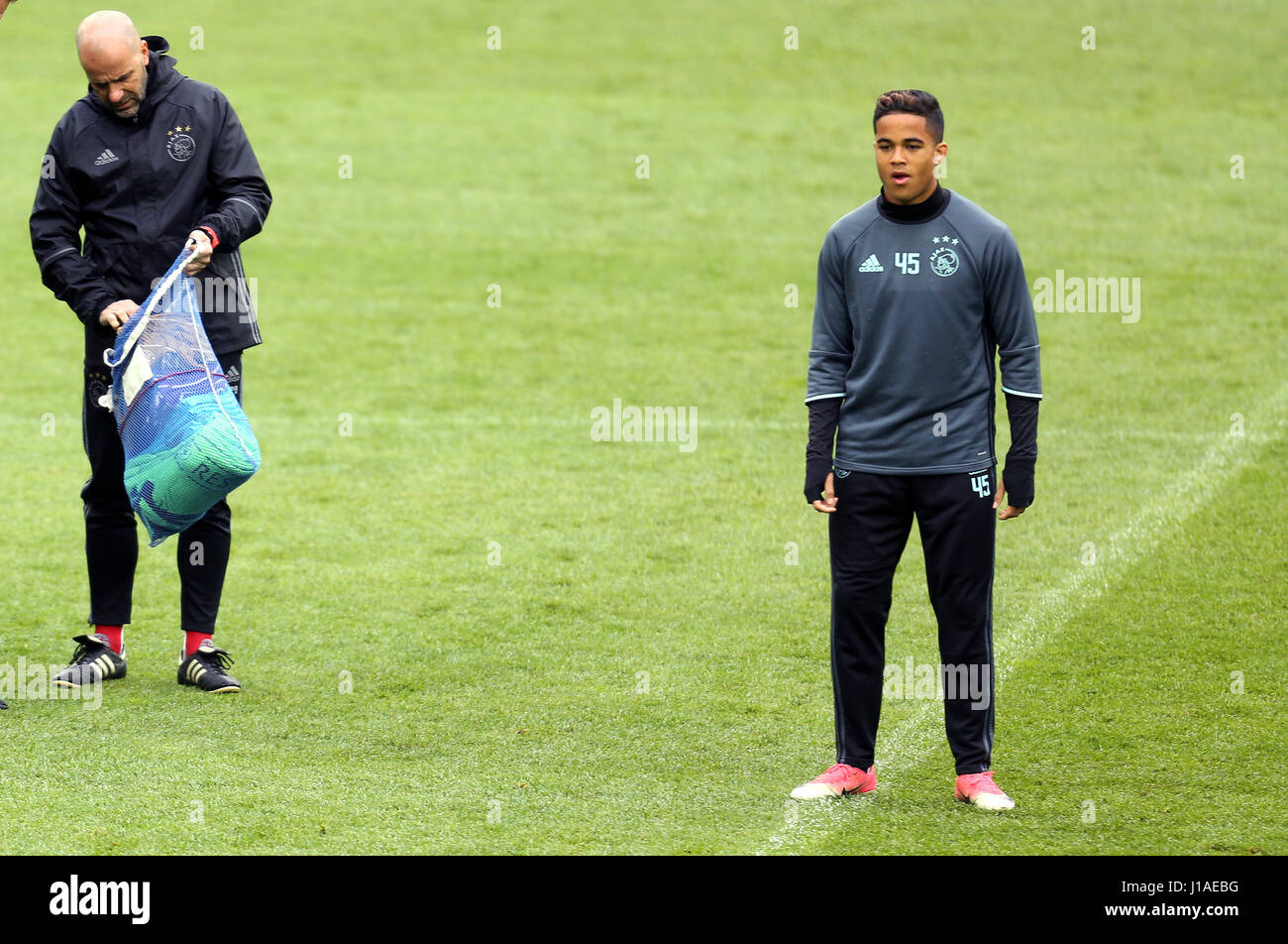 Gelsenkirchen, Germany. 19th Apr, 2017. Ajax Amsterdam player Justin Kluivert and his trainer Peter Bosz can be seen training in the Veltins Arena, in Gelsenkirchen, Germany, 19 April 2017. Ajax Amsterdam will play against FC Schalke 04 the 2nd-leg of their Europe League quarter final match on 20 April 2017. Photo: Ina Fassbender/dpa/Alamy Live News Stock Photo