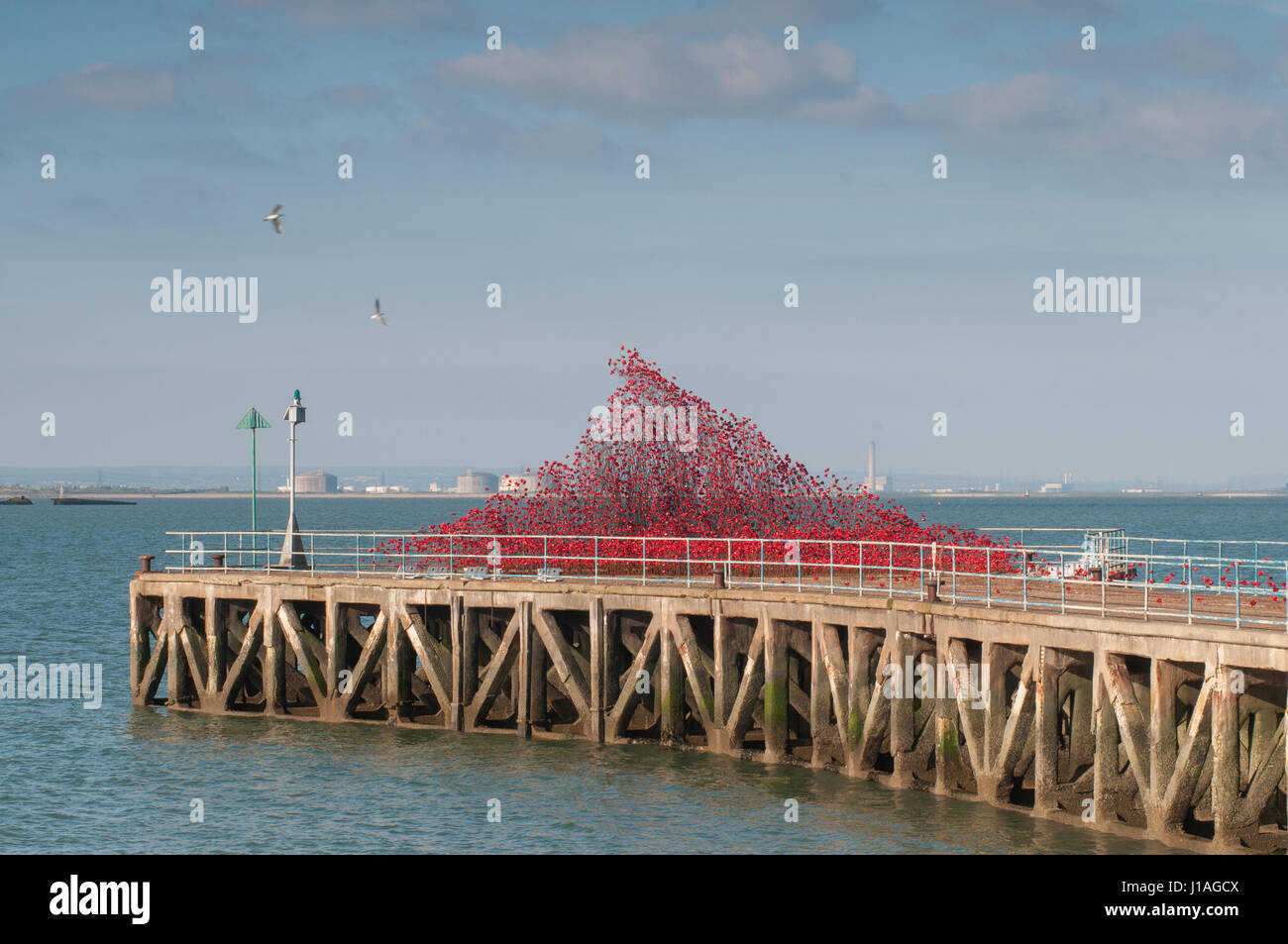Shoeburyness, Southend-on-Sea, Essex, UK. 19th Apr, 2017. Barge Pier, Gunners Park is host to Poppies: Wave, a sweeping arch of thousands of handmade bright red ceramic poppy heads by Artist Paul Cummins and Designer Tom Piper. Credit: Ben Rector/Alamy Live News Stock Photo