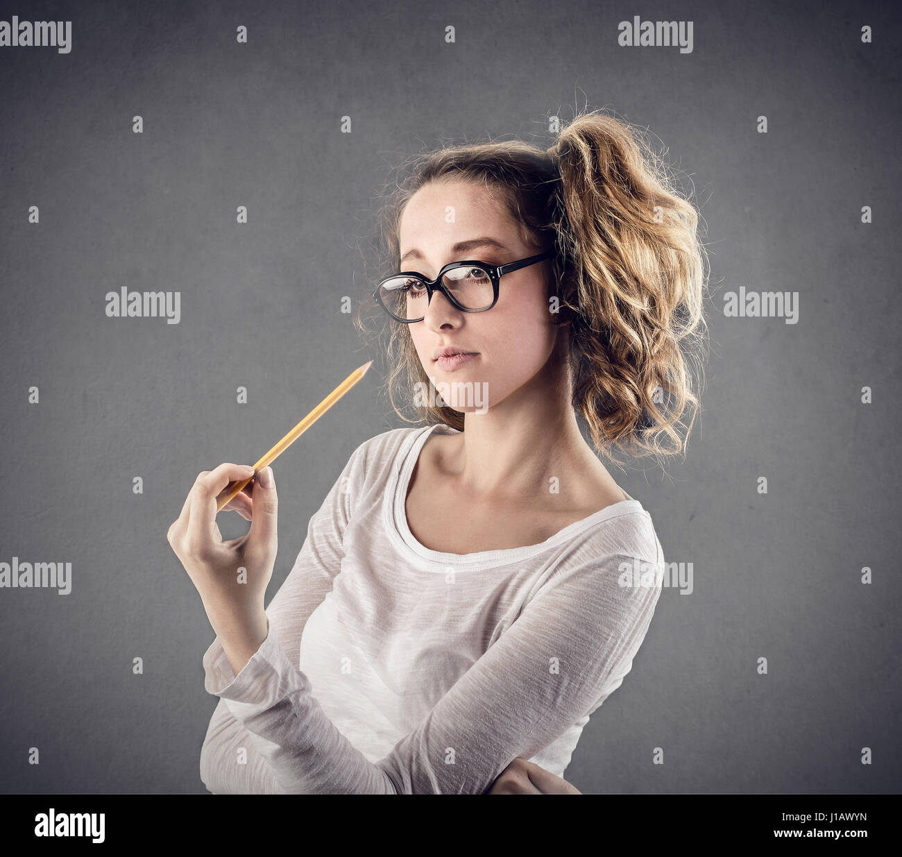 Student woman holding pencil Stock Photo - Alamy