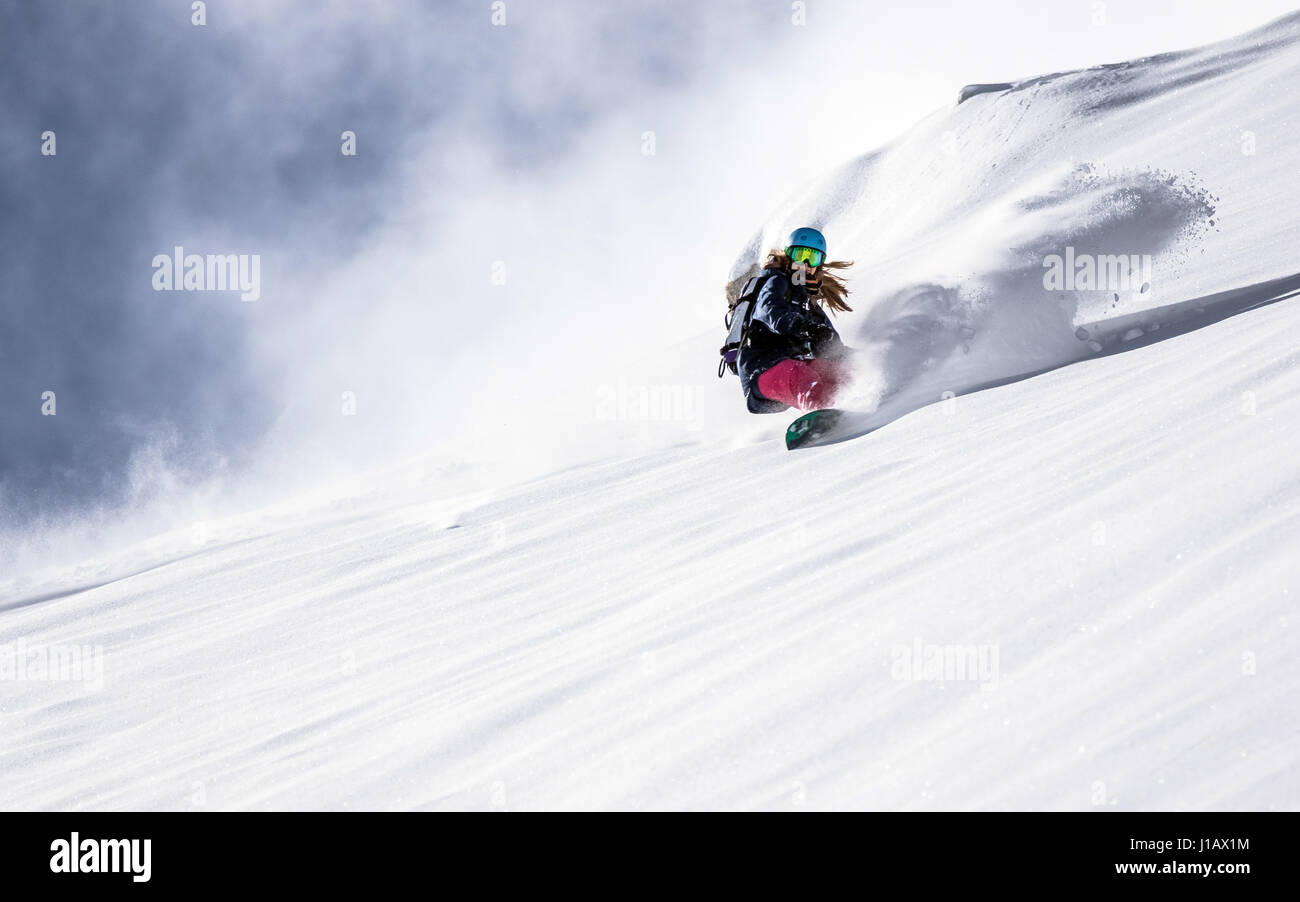 A snowboarder is flying down the Sportgastein ski region, Austria. Stock Photo