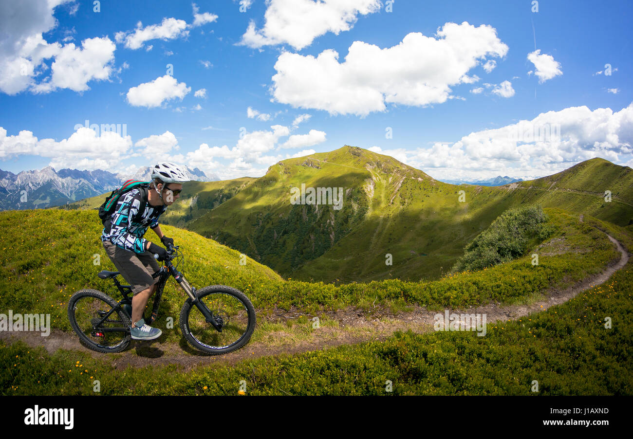 A mountain biker rides his bike in a beautiful landscape near Zell Am See at the Kaprun region, Austria. Stock Photo