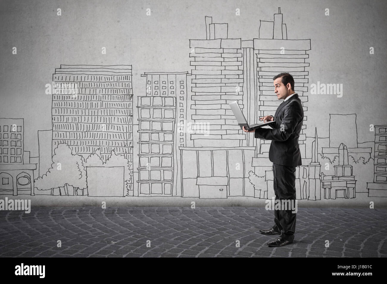 Businessman with drawn city as background Stock Photo