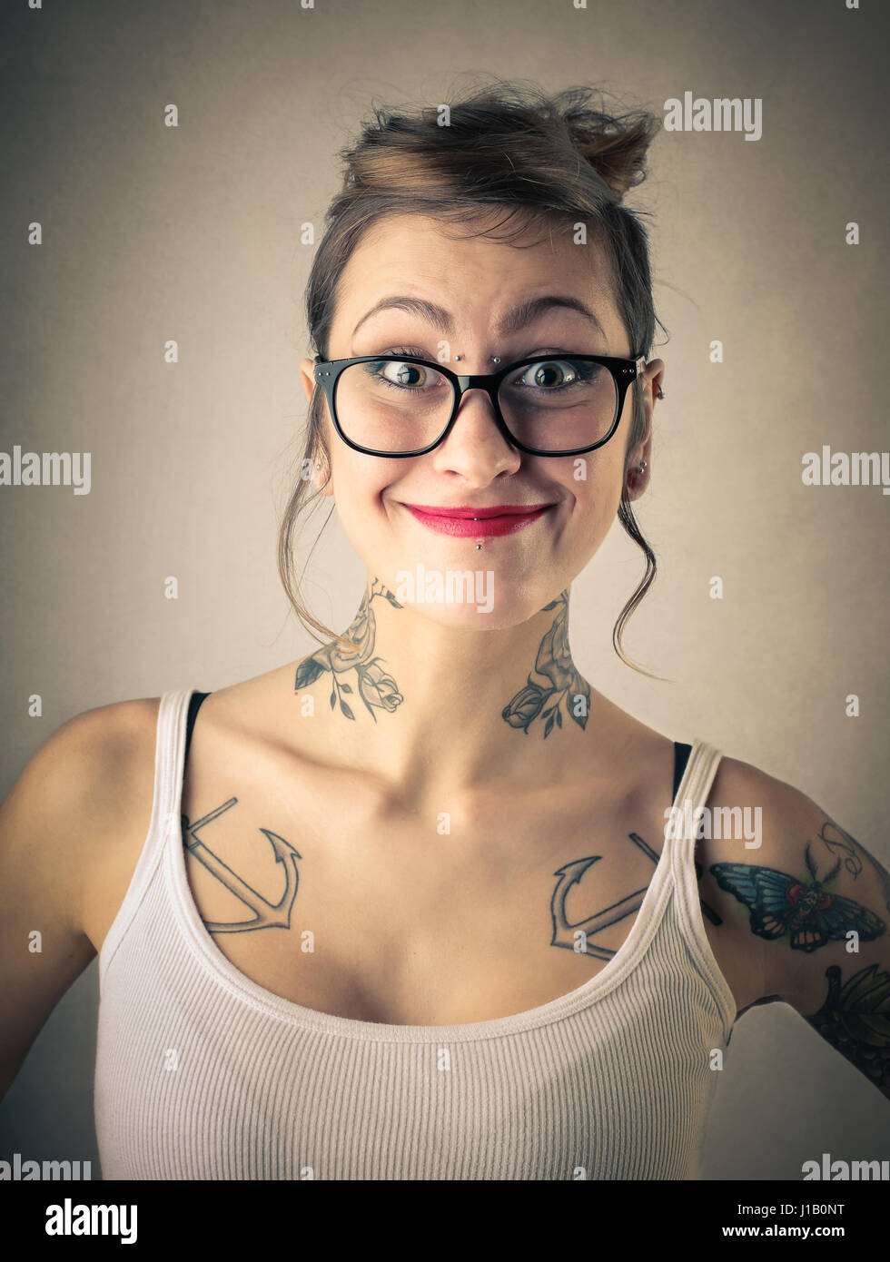 Tattooed woman smiling in glasses Stock Photo