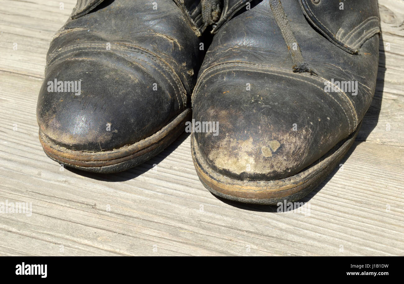 Old shoes on a wooden surface. Close-up Stock Photo - Alamy