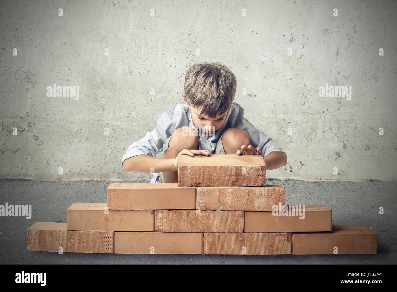 boy playing with bricks Stock Photo