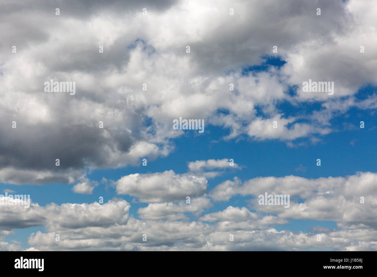 Cloudscape with white clouds against clear and blue sky Stock Photo - Alamy