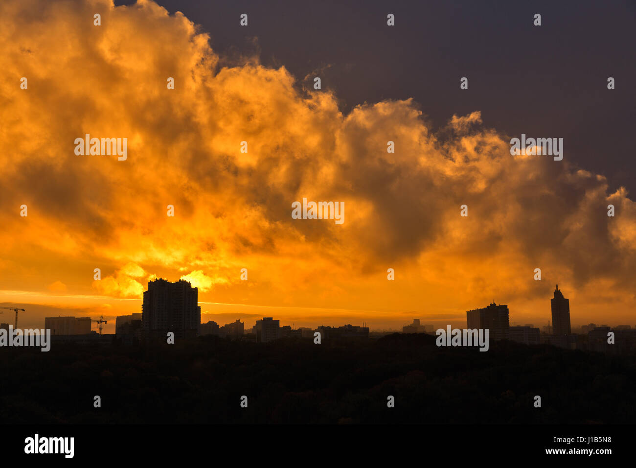 Urban sunset skyline with dramatic orange clouds. Kiev, Ukraine. Stock Photo