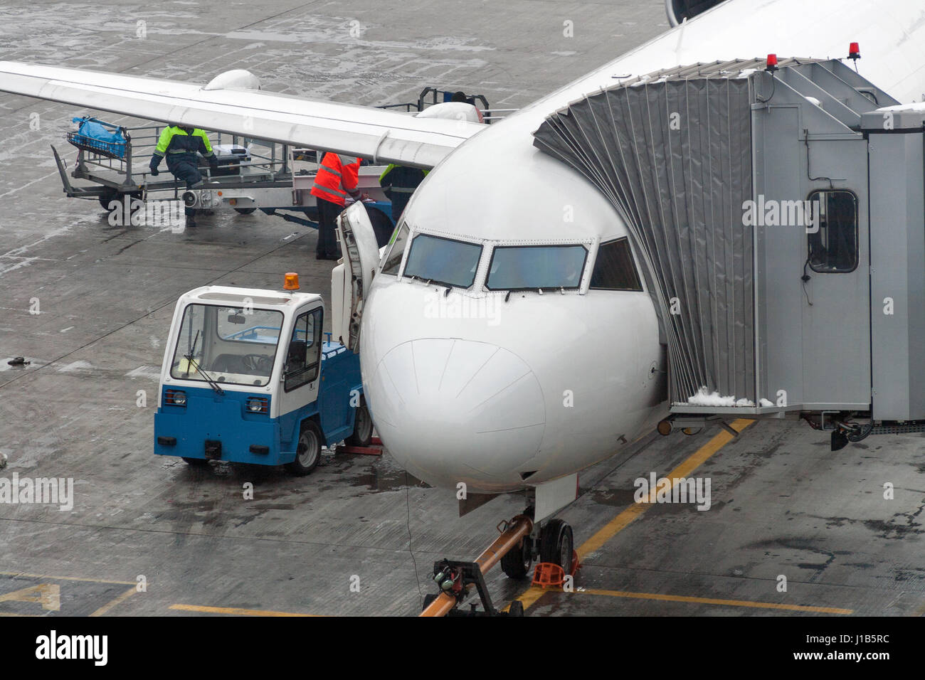 Aircraft with passage corridor being prepared for passenger boarding an airplane in a modern international airport. Stock Photo