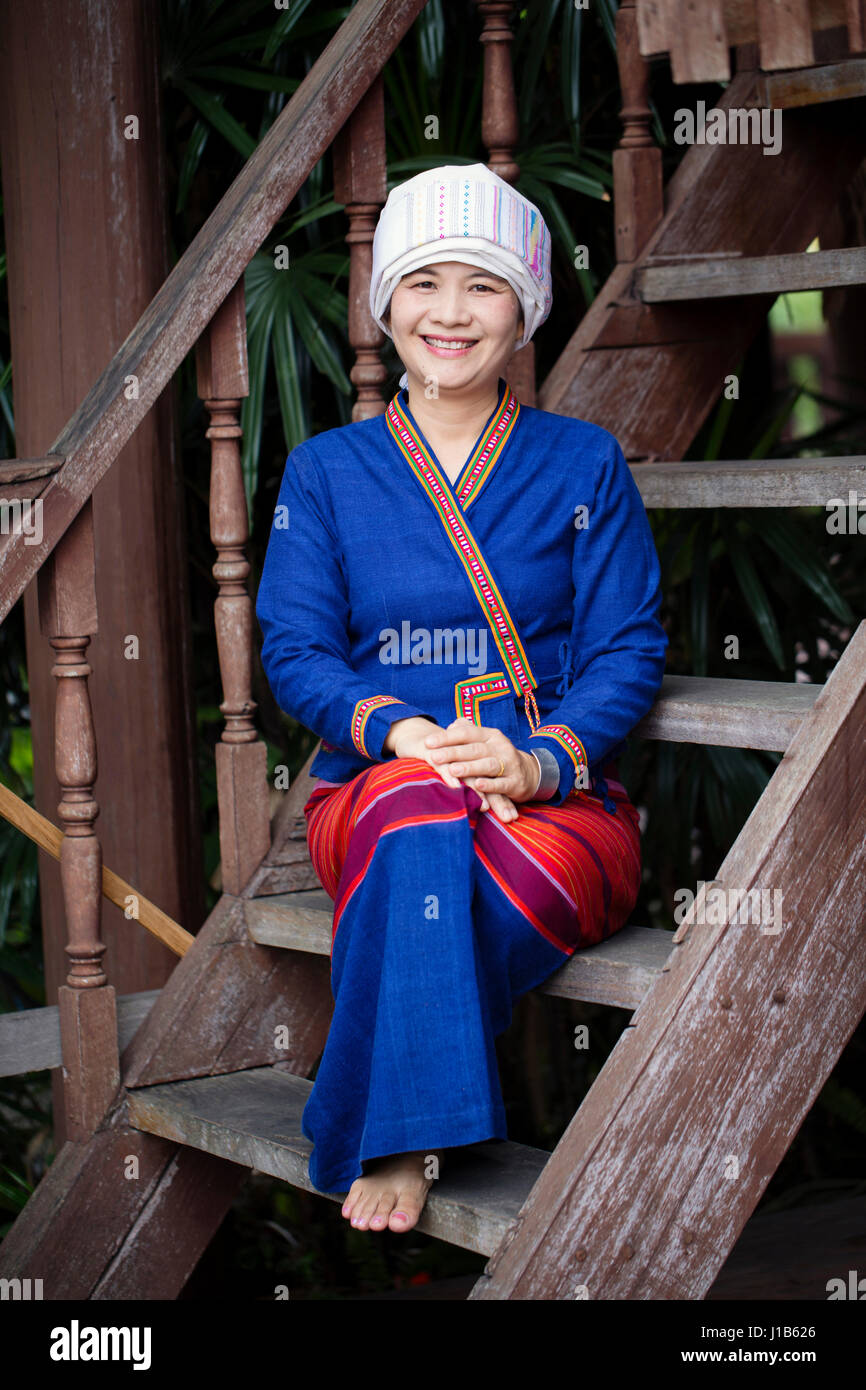 Asian woman wearing traditional clothing sitting on staircase Stock Photo